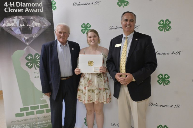 Accepting the 4-H Diamond Clover Award is Kaitlyn Johnson of Selbyville, shown with Sen. Dave Wilson, R-Lincoln, left, and Ernie Lopez, Delaware 4-H program leader. SUBMITTED PHOTOS